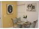 Small dining area with glass table and four chairs at 7108 Saint Andrews Ln, Sarasota, FL 34243