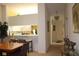 Dining area with kitchen pass-through and hardwood floors at 7108 Saint Andrews Ln, Sarasota, FL 34243