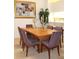 Elegant dining room featuring a large wood table and six striped chairs at 7108 Saint Andrews Ln, Sarasota, FL 34243