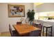 Bright dining room with wood table and chairs, kitchen view at 7108 Saint Andrews Ln, Sarasota, FL 34243