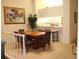 Dining room features a large table, chairs, and kitchen access at 7108 Saint Andrews Ln, Sarasota, FL 34243