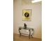 Condo entryway with console table and art at 7108 Saint Andrews Ln, Sarasota, FL 34243
