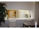 Kitchen features white cabinets and a breakfast bar at 7108 Saint Andrews Ln, Sarasota, FL 34243