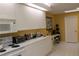 White kitchen cabinets and appliances, bright and airy at 7108 Saint Andrews Ln, Sarasota, FL 34243