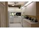 Well-lit kitchen boasts white cabinetry and modern appliances at 7108 Saint Andrews Ln, Sarasota, FL 34243