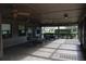 Screened lanai with tiled floor and seating at 7108 Saint Andrews Ln, Sarasota, FL 34243