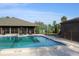 Community pool with lounge chairs and cabana at 7108 Saint Andrews Ln, Sarasota, FL 34243