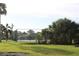 Community tennis court with green lawn at 7108 Saint Andrews Ln, Sarasota, FL 34243
