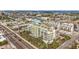 Aerial view of a modern building near the water, surrounded by other buildings and roads at 11605 Gulf Blvd # 505, Treasure Island, FL 33706