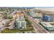 Wide aerial view of a coastal area, highlighting a multi-story building at 11605 Gulf Blvd # 505, Treasure Island, FL 33706
