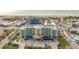 Aerial view of beachfront property, showcasing a multi-story building and ocean at 11605 Gulf Blvd # 505, Treasure Island, FL 33706