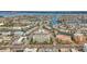 Aerial view showing a modern building in a coastal area with water access at 11605 Gulf Blvd # 505, Treasure Island, FL 33706