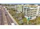 Aerial view showing a building's exterior and landscaping, located near a road at 11605 Gulf Blvd # 505, Treasure Island, FL 33706