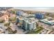 Aerial view of beachfront property, showcasing a multi-story building and ocean at 11605 Gulf Blvd # 505, Treasure Island, FL 33706