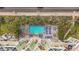 Aerial view of a multi-story building with a pool and surrounding landscape at 11605 Gulf Blvd # 505, Treasure Island, FL 33706