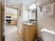 Bathroom with granite vanity, toilet and view into kitchen at 11605 Gulf Blvd # 505, Treasure Island, FL 33706