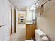 Bathroom with granite vanity, toilet and view into the kitchen at 11605 Gulf Blvd # 505, Treasure Island, FL 33706