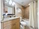 Clean bathroom with tub shower, granite countertop, and wood vanity at 11605 Gulf Blvd # 505, Treasure Island, FL 33706