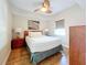 Bright bedroom with a queen bed, nightstands, and wood floors at 11605 Gulf Blvd # 505, Treasure Island, FL 33706