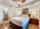 Bedroom with a queen bed, en-suite bathroom access, and wood floors at 11605 Gulf Blvd # 505, Treasure Island, FL 33706