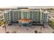Multi-story building with balconies, parking, and ocean views at 11605 Gulf Blvd # 505, Treasure Island, FL 33706