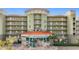 Building exterior showcasing a modern design and ample parking at 11605 Gulf Blvd # 505, Treasure Island, FL 33706