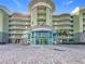 Modern building with glass entryway and spacious parking area at 11605 Gulf Blvd # 505, Treasure Island, FL 33706