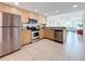 Modern kitchen with stainless steel appliances and light wood cabinets at 11605 Gulf Blvd # 505, Treasure Island, FL 33706