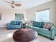 Living room boasts teal leather sofas and a coffee table at 11605 Gulf Blvd # 505, Treasure Island, FL 33706