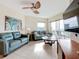 Living room with teal leather sofas and ocean view at 11605 Gulf Blvd # 505, Treasure Island, FL 33706