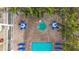 Aerial view of resort-style pool and spa with numerous lounge chairs at 11605 Gulf Blvd # 505, Treasure Island, FL 33706