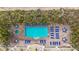 Aerial view showing a refreshing pool and spa with plenty of lounge chairs at 11605 Gulf Blvd # 505, Treasure Island, FL 33706