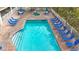 Inviting pool area with plenty of lounge chairs and a spa for relaxation at 11605 Gulf Blvd # 505, Treasure Island, FL 33706