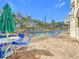 Community pool with ample lounge chairs and patio seating at 11605 Gulf Blvd # 505, Treasure Island, FL 33706
