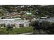 Aerial view of community with pool, lush landscaping, and numerous buildings at 12200 Vonn Rd # 2109, Largo, FL 33774
