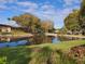 Tranquil canal-front view with lush landscaping and mature trees at 12200 Vonn Rd # 2109, Largo, FL 33774