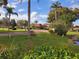Landscaped entrance to community featuring a bench and pond at 12200 Vonn Rd # 2109, Largo, FL 33774
