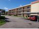 Two-story condo building with parking and landscaping at 12200 Vonn Rd # 2109, Largo, FL 33774
