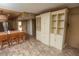 Condo kitchen features white cabinets, granite counters, and wooden bar stools at 12200 Vonn Rd # 2109, Largo, FL 33774