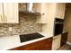 Modern kitchen with stainless steel appliances and tile backsplash at 12200 Vonn Rd # 2109, Largo, FL 33774