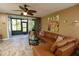 Spacious living room with leather sectional sofa and view of screened patio at 12200 Vonn Rd # 2109, Largo, FL 33774