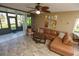 Living room with leather sectional and screened patio access at 12200 Vonn Rd # 2109, Largo, FL 33774