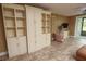 Living room has built-in shelving and tile flooring at 12200 Vonn Rd # 2109, Largo, FL 33774
