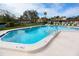 Community pool with surrounding lounge chairs at 12200 Vonn Rd # 2109, Largo, FL 33774