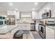 Modern white kitchen with granite countertops at 13151 87Th Pl, Seminole, FL 33776