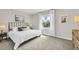Spacious bedroom with carpeted floor, large bed and a view of the backyard at 1508 Hammer Pl, Largo, FL 33774
