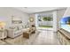 Bright living room with tiled floors, comfy sofa, and sliding glass doors leading to backyard at 1508 Hammer Pl, Largo, FL 33774