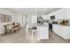 Modern kitchen with white cabinets, marble countertops, and stainless steel appliances at 1524 Hammer Pl, Largo, FL 33774