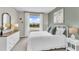 Serene bedroom with white bedding and a window showcasing a garden view at 1532 Hammer Pl, Largo, FL 33774