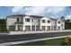 Modern townhome community with attached garages and neutral color palette at 1532 Hammer Pl, Largo, FL 33774